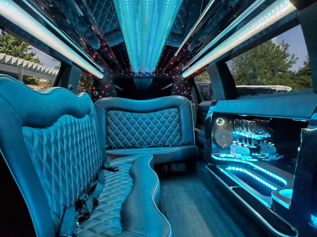 A limo car with blue lights and a white interior.