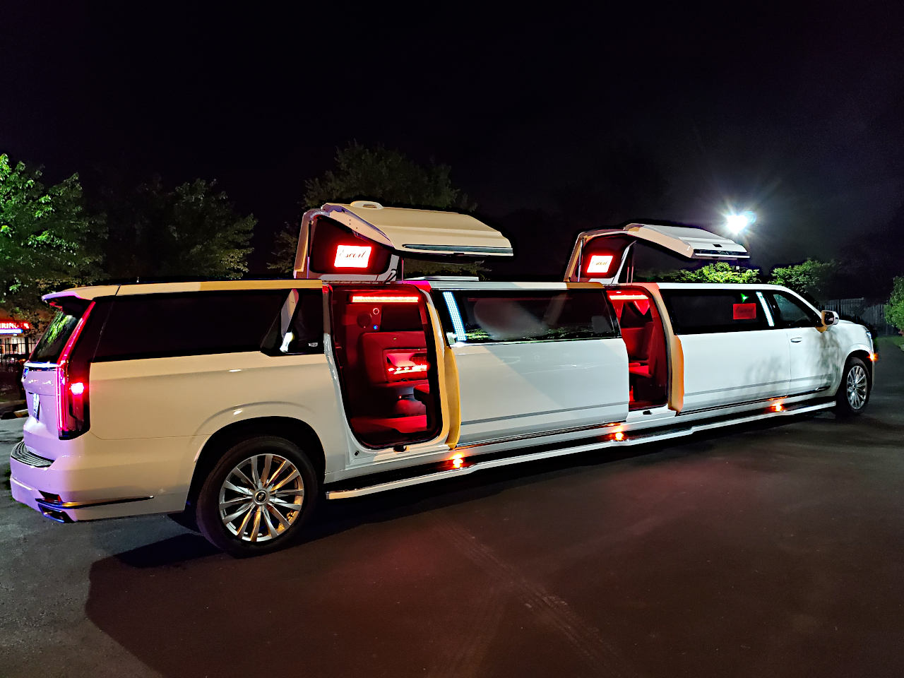 A white limo with lights on the side of it.