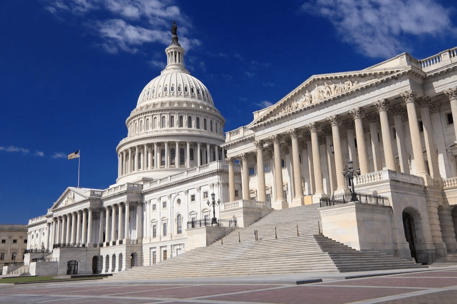 U.S. Capitol Building under clear blue sky.