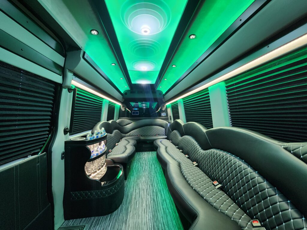 Luxury party bus interior with green lighting.