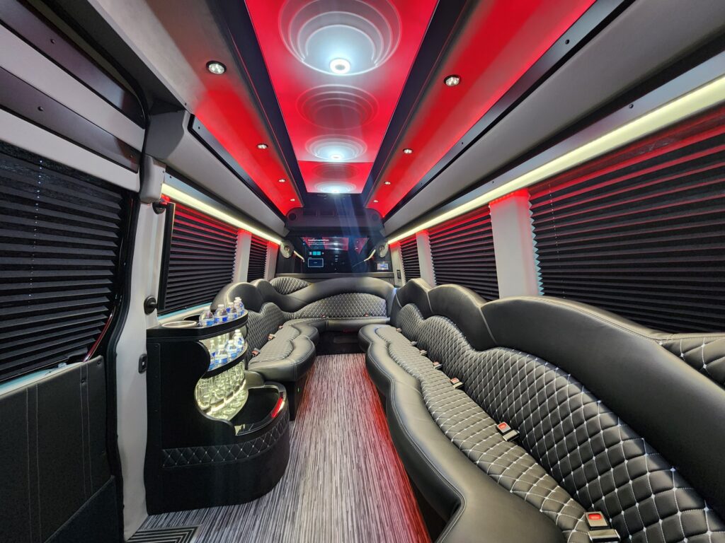 Luxury limousine interior with red ambient lighting.