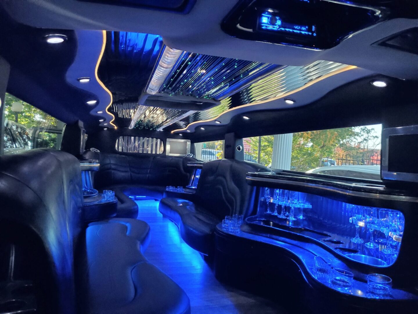 Luxury limousine interior with blue lighting.