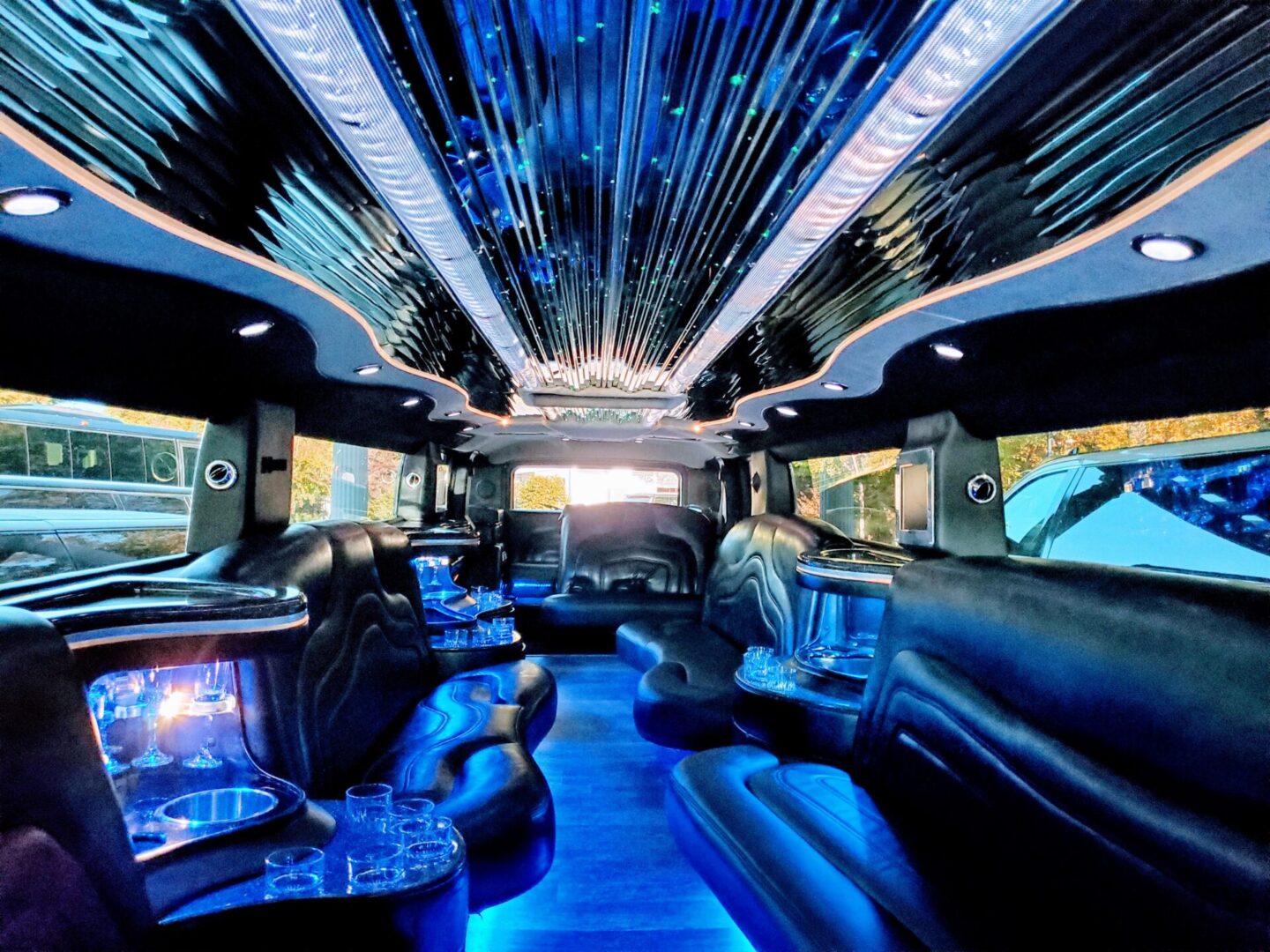 Luxurious limousine interior with blue lighting.