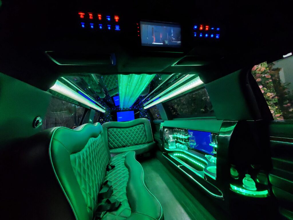 Luxurious limousine interior with green lighting.