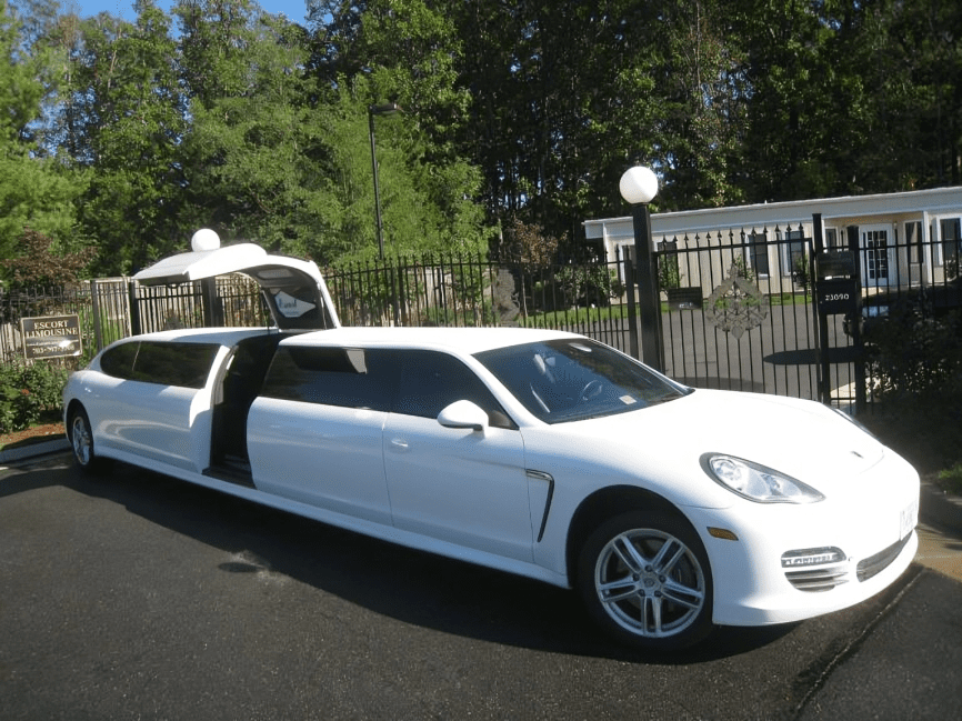 White stretch limousine parked near gate.